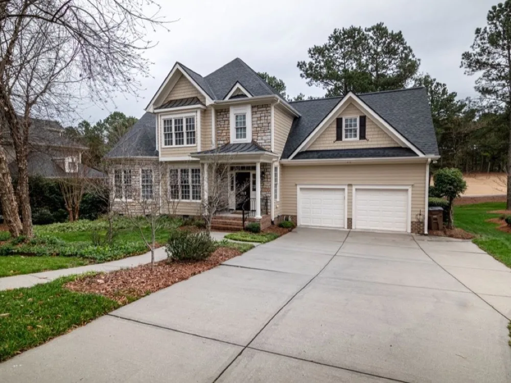 Suburban home with a wide poured concrete driveway