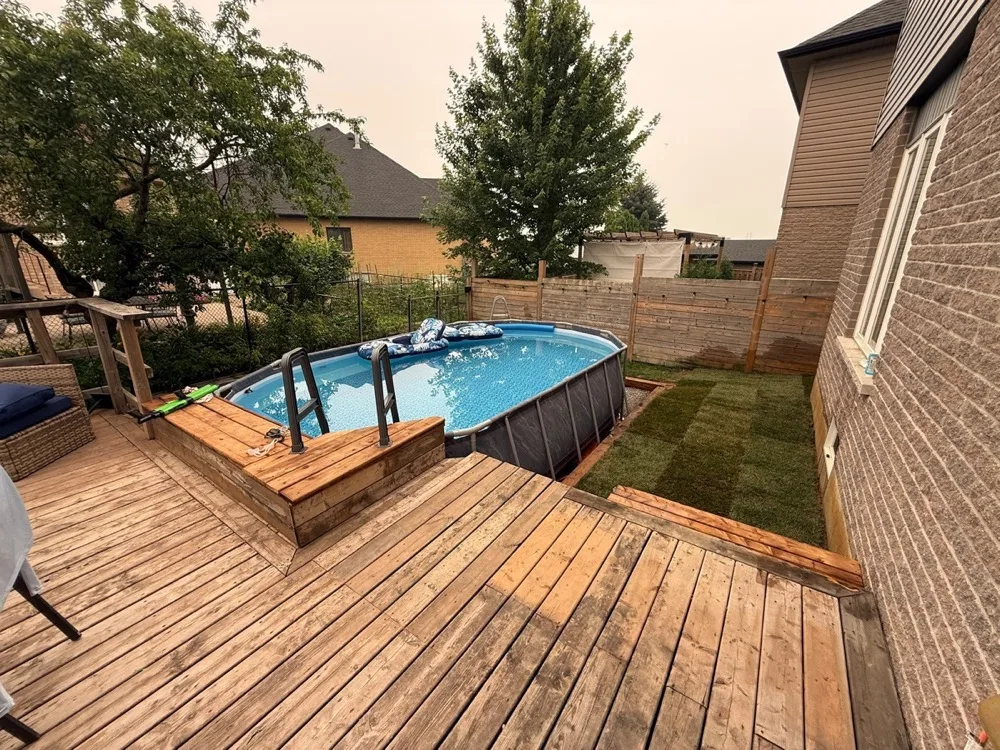 Wood deck and stairs built around an above-ground pool in Hamilton, Ontario