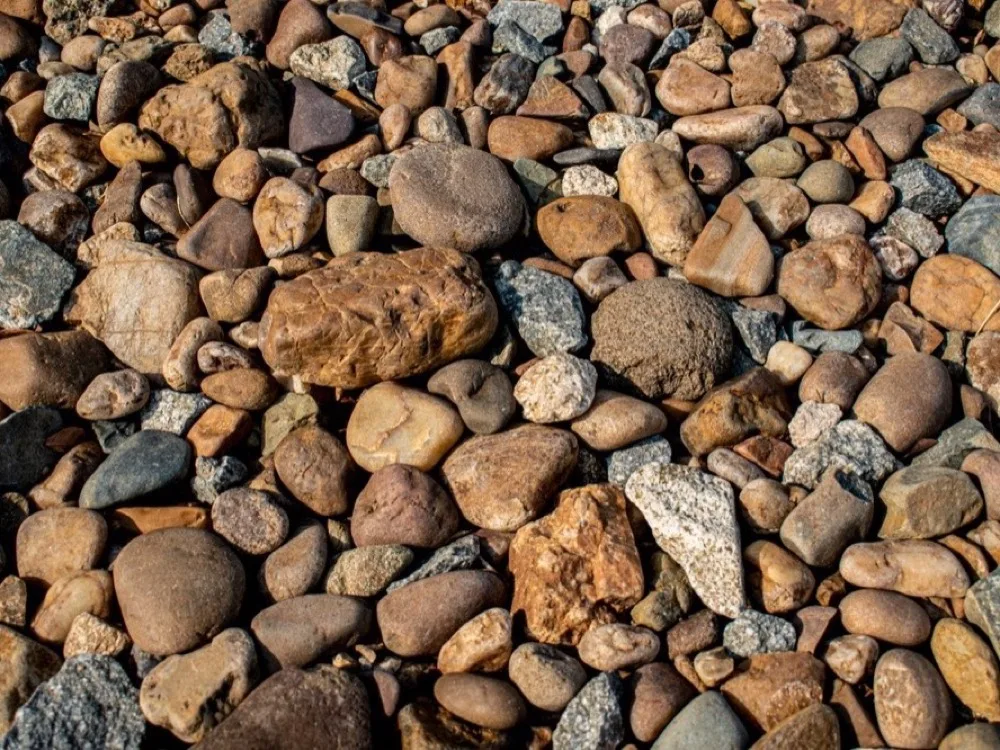 Close-up of smooth river rock used for decorative stone beds
