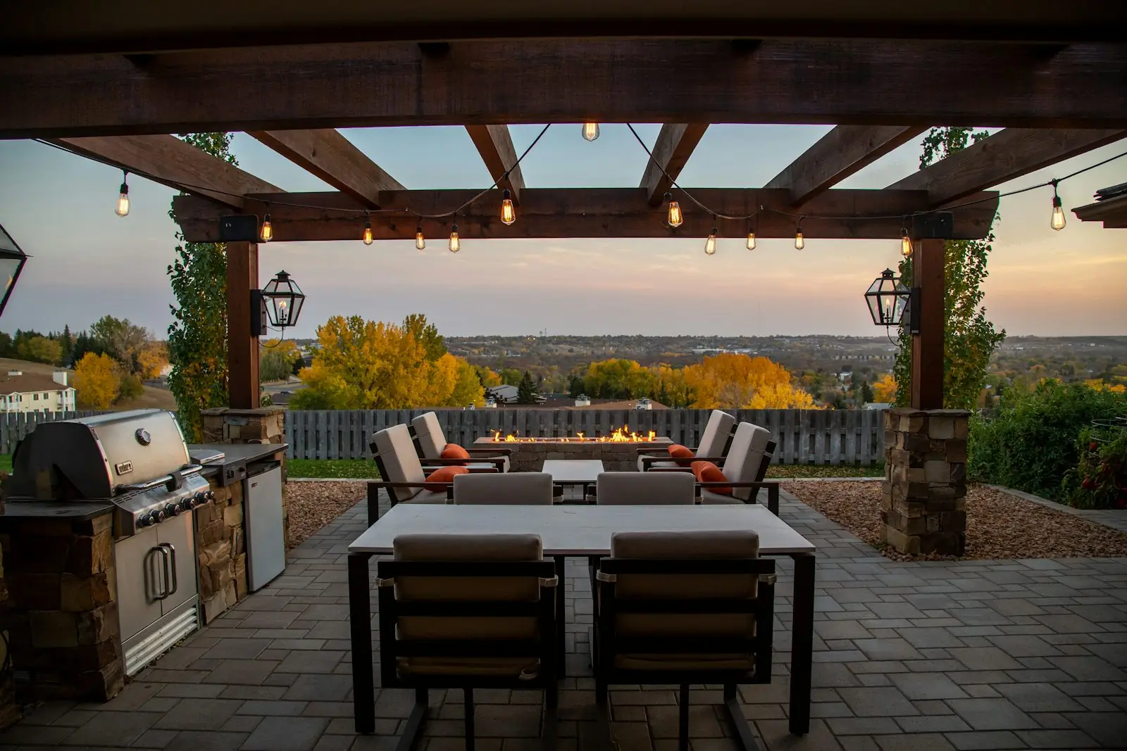 Finished stone patio with a built-in fire feature and seating area, a typical TrueLand Landscaping outdoor living project